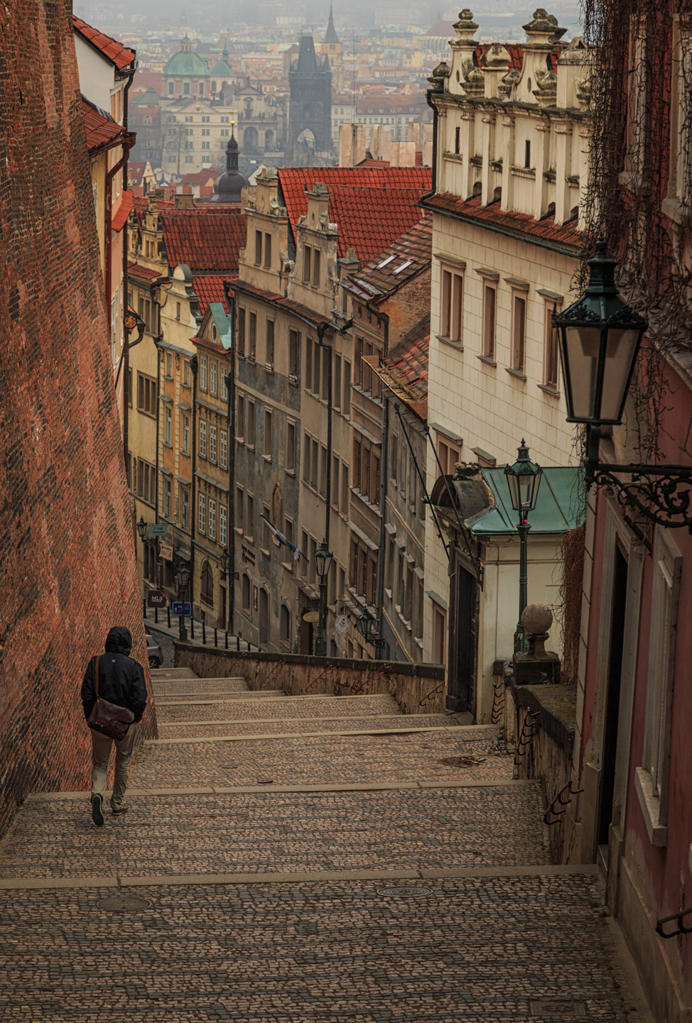 A person walks down the cobbled-stone stairs - one of our favourite pictures of Prague