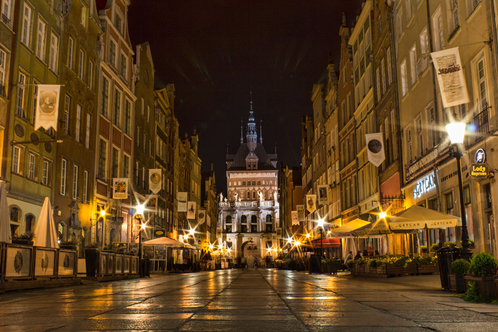 Patios line the street in Old Town Gdańsk at night