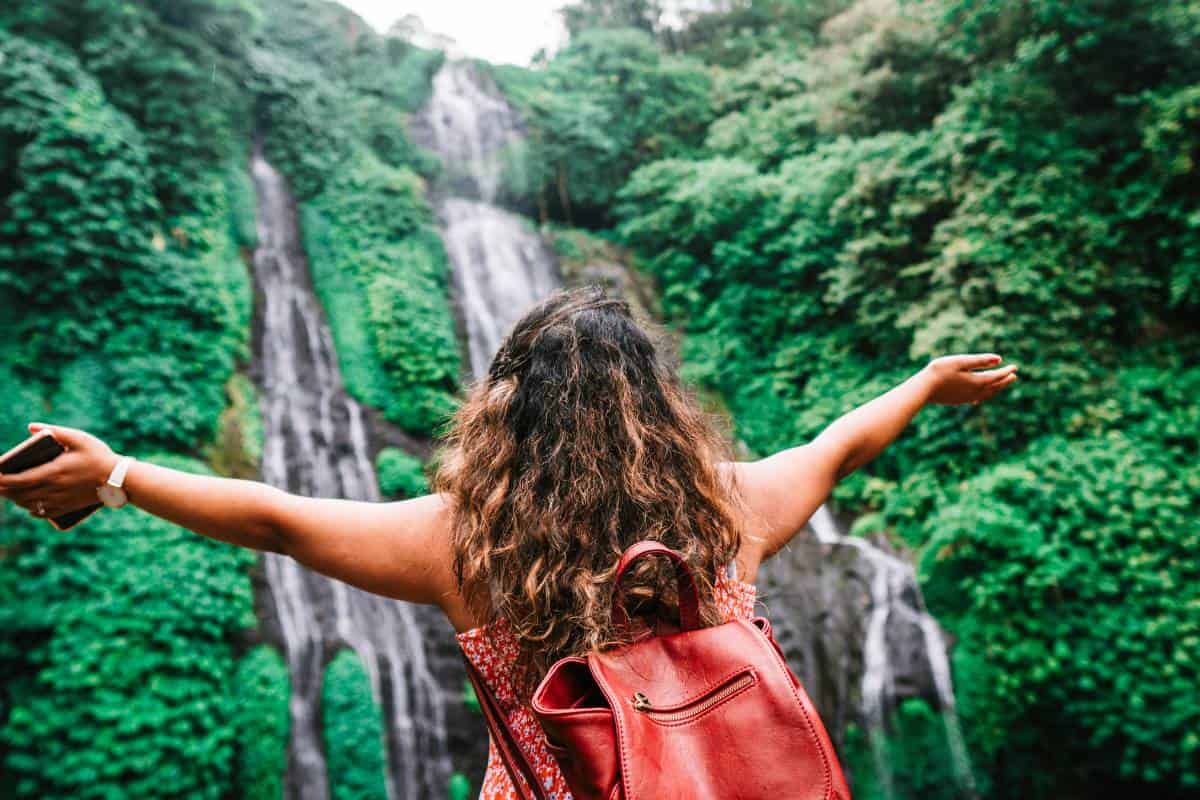girl with arms up traveling having fun