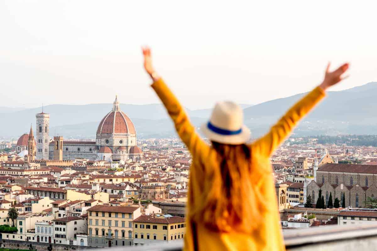 girl with arms up traveling having fun