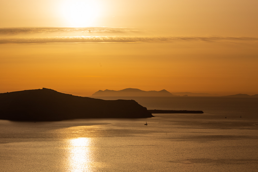 A yellow sky during sunset in Santorini