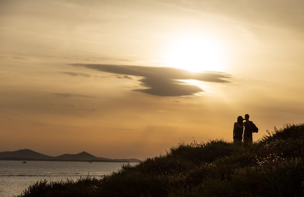 A couple shares the sunset in Naxos, Greece